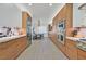 Modern kitchen with wood cabinets, stainless steel appliances, and open access to the dining area at 11099 Moonlight Fire Ct, Las Vegas, NV 89135