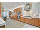 Beautiful modern kitchen with stainless steel appliances, wood cabinetry, and a view of the dining area at 11099 Moonlight Fire Ct, Las Vegas, NV 89135