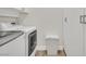 Modern laundry area equipped with front-load washer, dryer, and ample storage at 11099 Moonlight Fire Ct, Las Vegas, NV 89135