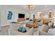 Bright and airy living room with plush seating and seamless access to the modern kitchen at 11099 Moonlight Fire Ct, Las Vegas, NV 89135