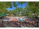 Community playground with dinosaur sculptures and safety surface, surrounded by mature trees and landscaping at 11099 Moonlight Fire Ct, Las Vegas, NV 89135