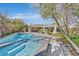 Stunning backyard oasis with a sparkling pool, spa, and covered patio, perfect for outdoor entertaining at 11099 Moonlight Fire Ct, Las Vegas, NV 89135