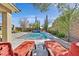 Beautiful pool surrounded by lush landscaping and comfortable lounge chairs at 11099 Moonlight Fire Ct, Las Vegas, NV 89135