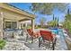 Enjoy a refreshing swim in the pool surrounded by manicured landscaping and comfortable lounge chairs at 11099 Moonlight Fire Ct, Las Vegas, NV 89135