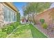 Beautifully landscaped side yard with artificial turf, leading to a view of the refreshing pool at 11099 Moonlight Fire Ct, Las Vegas, NV 89135