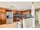 Well-lit kitchen with granite countertops, stainless steel appliances, tile backsplash, and dark wood cabinets at 11845 Tevare Ln # 2069, Las Vegas, NV 89138