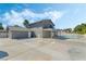 Spacious backyard showcasing home exterior, pool, patio, and a large concrete pad at 1300 Oak Tree Ln, Las Vegas, NV 89108