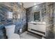 Luxurious bathroom with dark marble walls, sleek white vanity, and modern fixtures at 1300 Oak Tree Ln, Las Vegas, NV 89108
