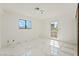 Well-lit bedroom featuring marble floors, bright windows, and a back door at 1300 Oak Tree Ln, Las Vegas, NV 89108