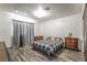Charming bedroom featuring wood floors, warm lighting, and decorative furnishings at 1300 Oak Tree Ln, Las Vegas, NV 89108