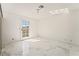 Bright bedroom featuring marble floors and a door leading outside to a backyard at 1300 Oak Tree Ln, Las Vegas, NV 89108