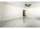 Bright bedroom featuring white walls, a ceiling fan, and marble tile flooring at 1300 Oak Tree Ln, Las Vegas, NV 89108