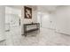Bright entryway featuring modern black and gold decor, marble-look floors, and access to the kitchen at 1300 Oak Tree Ln, Las Vegas, NV 89108