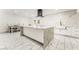 Elegant eat-in kitchen featuring a marble center island, white cabinets, and stainless steel appliances at 1300 Oak Tree Ln, Las Vegas, NV 89108