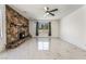 Spacious living room with a rustic stone fireplace, sleek tile flooring, and large windows at 1300 Oak Tree Ln, Las Vegas, NV 89108