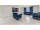 Cozy living room with an elegant blue velvet sofa and chair set and bright blue curtains at 1300 Oak Tree Ln, Las Vegas, NV 89108