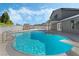 Inviting backyard pool featuring a diving board, attached hot tub, and privacy fencing at 1300 Oak Tree Ln, Las Vegas, NV 89108