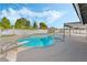 Backyard pool with diving board surrounded by lush greenery and blue skies at 1300 Oak Tree Ln, Las Vegas, NV 89108