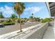 Exterior view of a tree-lined street with well-maintained homes and green landscaping at 1300 Oak Tree Ln, Las Vegas, NV 89108