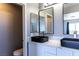 This bathroom has two black basin sinks on a white counter, and a toilet at 1416 Swanbrooke Dr, Las Vegas, NV 89144