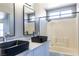 Bathroom features dual sinks with black fixtures and tub/shower combo at 1416 Swanbrooke Dr, Las Vegas, NV 89144