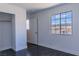 Bright bedroom features a large window offering neighborhood views and a closet with a wooden rod at 1416 Swanbrooke Dr, Las Vegas, NV 89144
