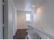 Upstairs hallway featuring a staircase with wooden railing and neutral paint at 1416 Swanbrooke Dr, Las Vegas, NV 89144