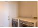 Convenient laundry room features updated washer and dryer next to a doorway at 1416 Swanbrooke Dr, Las Vegas, NV 89144