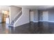 Open-concept space featuring a staircase, neutral color palette, and dark wood floors at 1416 Swanbrooke Dr, Las Vegas, NV 89144