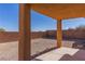 Exterior patio features large support beams and a rock filled yard enclosed by a brick wall at 1416 Swanbrooke Dr, Las Vegas, NV 89144