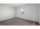 Clean bedroom with neutral carpet and a large window allowing natural light to fill the space at 1705 Desert Path Ave, North Las Vegas, NV 89032