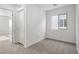Bright bedroom with neutral carpet, a window for natural light, and a closet for storage at 1705 Desert Path Ave, North Las Vegas, NV 89032