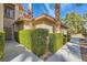 Attractive front entrance with neatly trimmed hedges and desert landscaping for a welcoming appeal at 2050 W Warm Springs Rd # 2922, Henderson, NV 89014