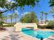 Community pool and landscaped lounging area with mature trees and pool bridge at 2050 W Warm Springs Rd # 2922, Henderson, NV 89014