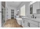 Bright bathroom featuring modern fixtures, a soaking tub, dual sinks, and a glass-enclosed shower at 2325 Janesville Ln, Henderson, NV 89044