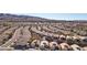 A high-angle view shows a desert community with evenly spaced houses and mountain backdrop at 2511 Jada Dr, Henderson, NV 89044