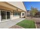 Outdoor patio with an artificial lawn and a ceiling fan overlooking the backyard at 2511 Jada Dr, Henderson, NV 89044