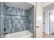 Modern bathtub and shower with sleek tile surround, black fixtures, and access to an adjacent bedroom at 2605 Amarillo St, Las Vegas, NV 89102