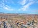 Expansive aerial view of a residential community with mountain views under a bright blue, partly cloudy sky at 3004 Barrett Springs Ave, Henderson, NV 89044