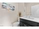 Well-lit half-bathroom with dark cabinet under a white sink at 3004 Barrett Springs Ave, Henderson, NV 89044