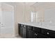 Bright bathroom featuring a bathtub/shower combo and dark cabinetry at 3004 Barrett Springs Ave, Henderson, NV 89044