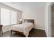 Bright bedroom with a large window, wood-look floors, and a classic bed frame at 3004 Barrett Springs Ave, Henderson, NV 89044