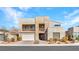 Contemporary two-story home featuring stone accents, balcony, and manicured landscaping at 3004 Barrett Springs Ave, Henderson, NV 89044