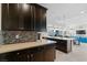 Kitchen with dark cabinetry, light countertops, and an open design flowing into the living area at 3004 Barrett Springs Ave, Henderson, NV 89044