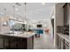 Open-concept kitchen with a large island that offers backyard and living room views at 3004 Barrett Springs Ave, Henderson, NV 89044