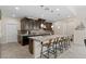 Modern kitchen with a large island, dark cabinetry, pendant lighting, and stainless steel appliances at 3004 Barrett Springs Ave, Henderson, NV 89044