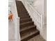 Elegant staircase with dark wood steps, white railings, and a carpeted landing at 3004 Barrett Springs Ave, Henderson, NV 89044