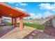 Serene backyard with covered patio, lush grass, and a charming fountain, perfect for relaxation and entertainment at 3920 Geist Ave, Las Vegas, NV 89115