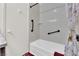 Clean bathroom featuring black safety bars, neutral colored shower curtain and a large white tub at 3920 Geist Ave, Las Vegas, NV 89115