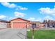 Charming single-story home featuring a colorful exterior, attached garage, and well-maintained lawn with ornamental decorations at 3920 Geist Ave, Las Vegas, NV 89115